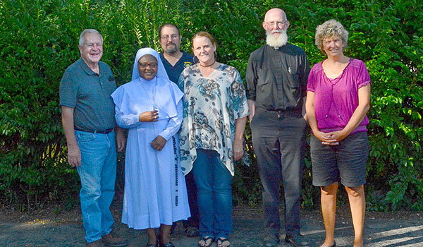 Jim Claire, Sister Stan Terese Mario Mumuni, MASEL, Cary Mikolajczyk, Amy Mikolajczyk, Father John Cullen and Jen Spoth have been helping to raise money for a bus for Sister Stan's orphanage. (Jason Jordan/Evening Tribune Photo)