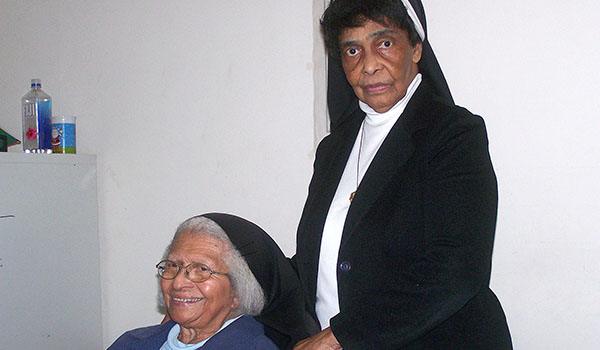 Sister Timothy Howard, OSP (seated), has spent nearly 50 years introducing young students to the love of Jesus Christ.She and Sister Noreen Smith, OSP, who both work at NativityMiguel Middle School in Buffalo, are the only remaining Oblate sisters of Providence currently serving in the Diocese of Buffalo.