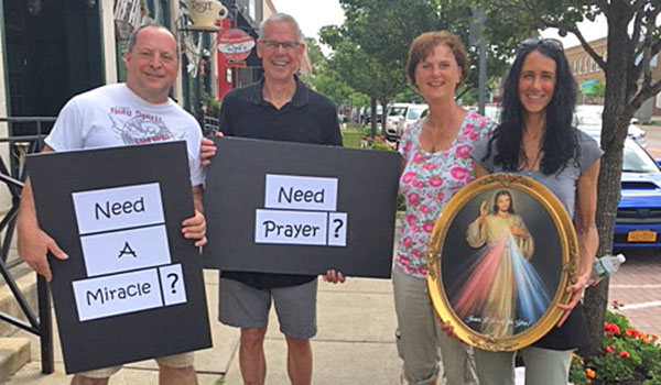 St. Paul Street Evangelizers from various parishes offer prayer in the streets for anyone who would like to feel God's intimate love and healing power. On Saturday, June 30, Tony Violanti, Deacon Michael Dulak, Tammy Stanek and Lisa Benzer headed out to East Aurora to pray for those in need. (Courtesy of St. Vincent's)