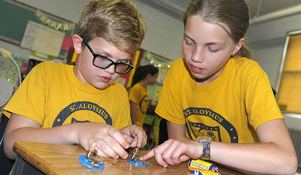 St. Aloysius School students Jack Gugino and Madeleine Griffin collaborate to assemble a circuit as part of the school's STREAM program. (Dan Cappellazzo/Staff Photographer)