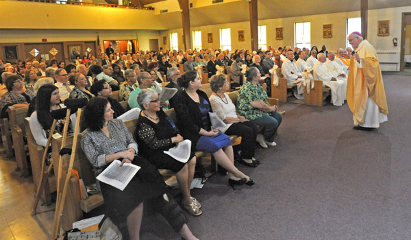 Bishop Richard Malone speaks to the congregation of St. Anthony's Church during their centennial Mass in Lackawanna. (Dan Cappellazzo/Staff Photographer)