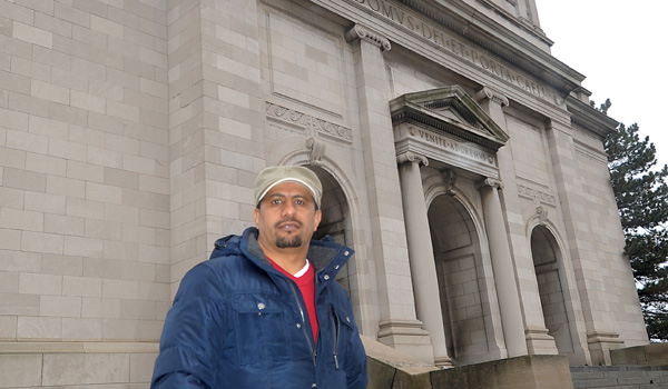 Ammar Shaibi stands in front of the former St. Gerard Church on Bailey Avenue and East Delavan Street in Buffalo. The church is set to sell to a group of Muslim backers, who will turn it into a mosque. (Dan Cappellazzo/Staff Photographer)