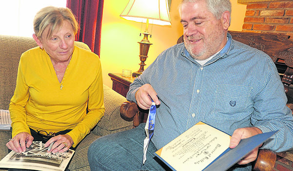 Debbie Doster Miller and John O'Hara, both graduates of St. Gerard's class of 1968, share memories of their time at the now-closed school, which was located at the corner of Bailey Avenue and Delavan Avenue. The two are planning a reunion. (Dan Cappellazzo/Staff Photographer)