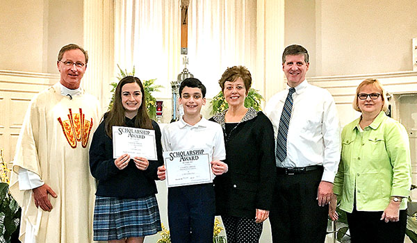 The Briana Talty Memorial Scholarship is awarded to Alyssa Barnum (second from left) and Colin Richey (third from left) at St. John the Baptist School in Kenmore. Joining them are Father Michael Parker (left), Dawne and Tom Talty (third and second from right) and Principal Cynthia Jacobs (right). (Courtesy of St. John the Baptist School)