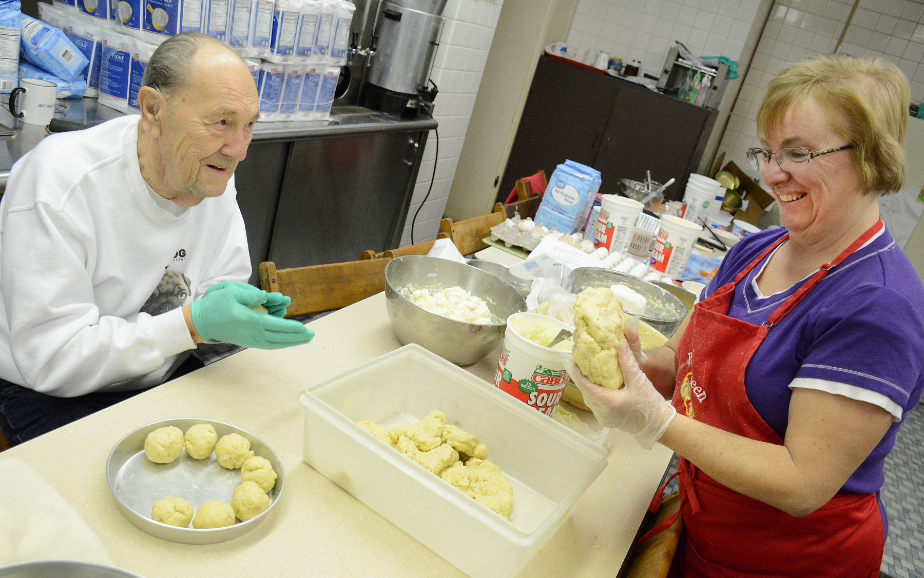 Diane Czajka and fellow St. John Kanty parishioner Ben Lisiecki form the dough which will become cheese pierogi made by volunteers and parishioners in the St John Kanty kitchen. Czajka, who leads the culinary fund raising effort for the historic Eastside church, has been a parishioner for 58 years, and Lisiecki for 61 years. 
Dan Cappellazzo/Staff photographer