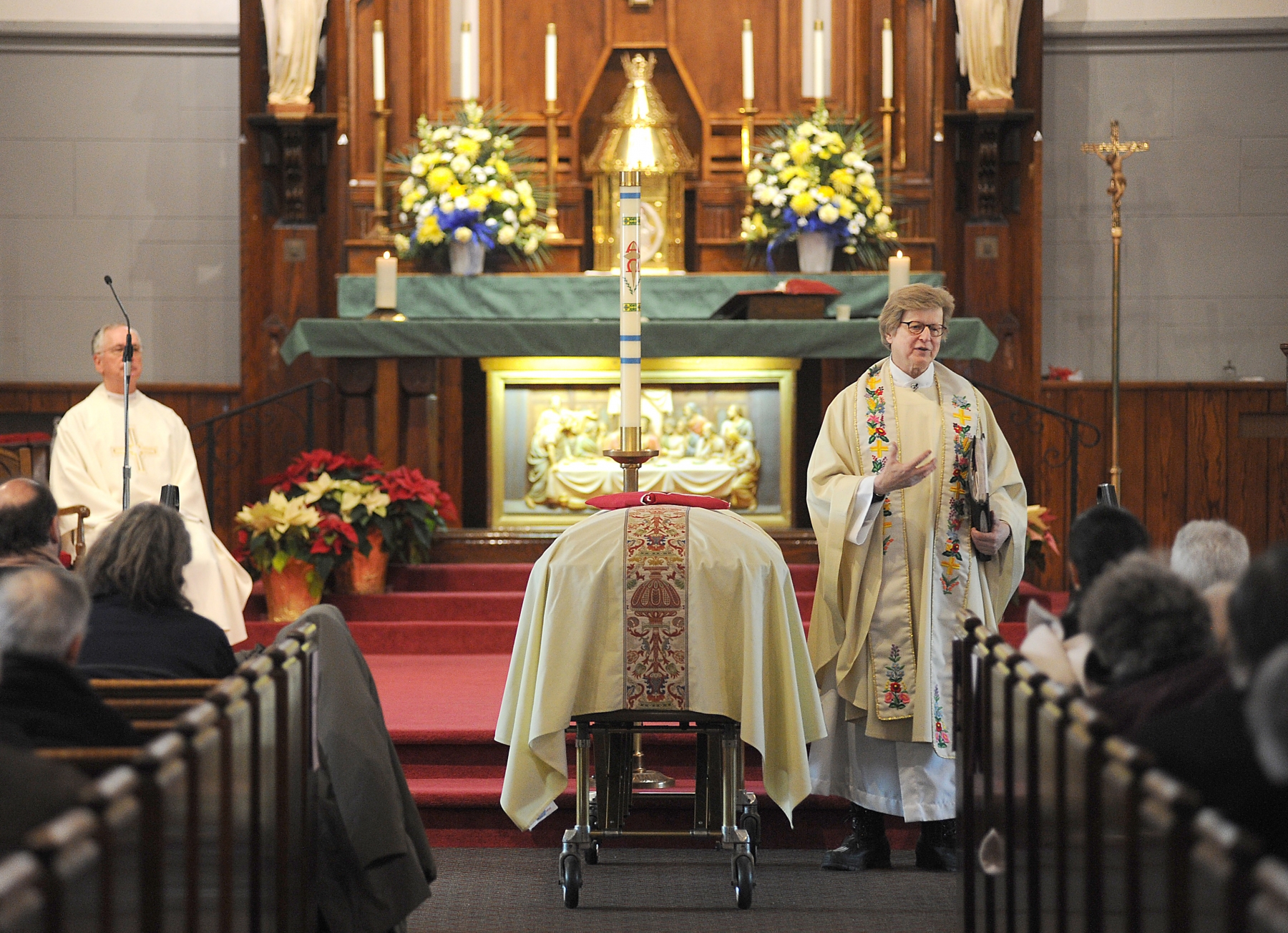 Flanked by the casket of Tibor Baranski's Father Richard Augustine speaks about the strong faith and life works of Baranski during his Funeral Mass at Christ the King Parish in Snyder. Baranski, an Amherst native, emigrated from Hungary where he helped 3000 Jews escape the nazi occupation during WWII.
Dan Cappellazzo/Staff photographer