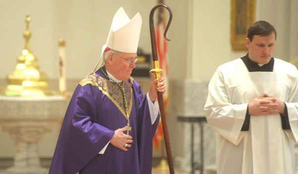 Bishop Richard J. Malone wears purple vestments during Ash Wednesday services. The color purple is a symbol of penance and the color garment Jesus wore during his passion. It is a fitting color for us to maintain during the days in which we focus on our own reality of sin.