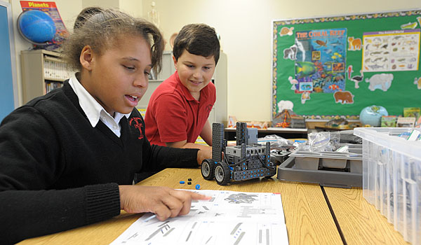 Catholic Academy of Niagara Falls students JaNesha Peay and Matthew Kaminska build and test their robots after school as part of the school's STREAM curriculum. (File Photo)