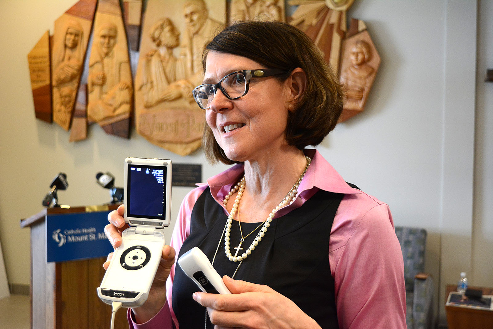 Patrick J. Buechi/Staff - Aimee Gomlak, vice president for Women's Health with Catholic Health, shows a hand-held ultrasound machine that was acquired by the Knights of Columbus and the diocesan Office of Pro-Life Activities. With the ability to detect a fetal heartbeat at six weeks, these small devices have been an asset to health care workers. 