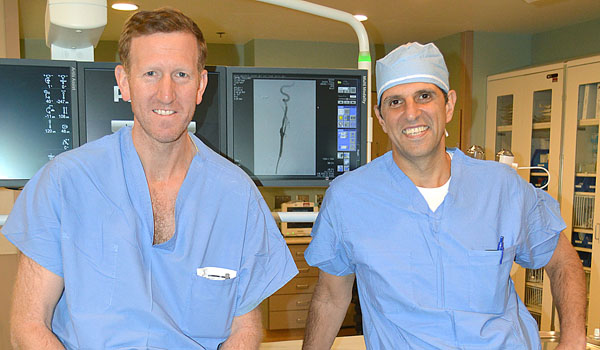 A new procedure being performed by Dr. Roger Wolcott (left) and Dr. Paul Anain, vascular surgeons at Catholic Health's Sisters of Charity Hospital, is offering new hope for patients suffering from carotid artery disease.