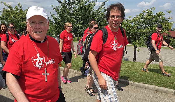 Bishop Richard J. Malone (left) and Michael Slish of the Diocesan Youth and Young Adult Ministry department walk with other World Youth Day pilgrims around Krakow, Poland. (Patrick J. Buechi/Staff) 