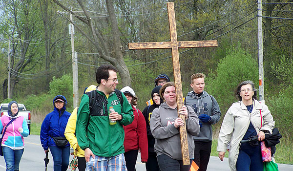 Nearly 50 World Youth Day pilgrims make the 15-mile march from St. Brendan's on the Lake Parish in Newfane to Our Lady of Fatima Shrine in Lewiston. The pilgrims spent nearly nine hours walking to prepare themselves for the hiking they will do in Krakow, Poland this July. (Patrick J. Buechi)