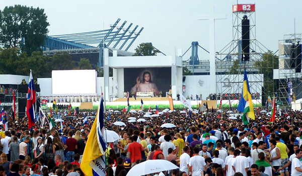 A copy of St. Faustian's Divine Mercy image serves as a backdrop for the opening Mass of World Youth Day 2016. The Mass, celebrated by Cardinal Stanislaw Dziwisz and dozens of other clergy, took place in Krakow's Blonia Park on July 26. (Patrick J. Buechi/Staff)