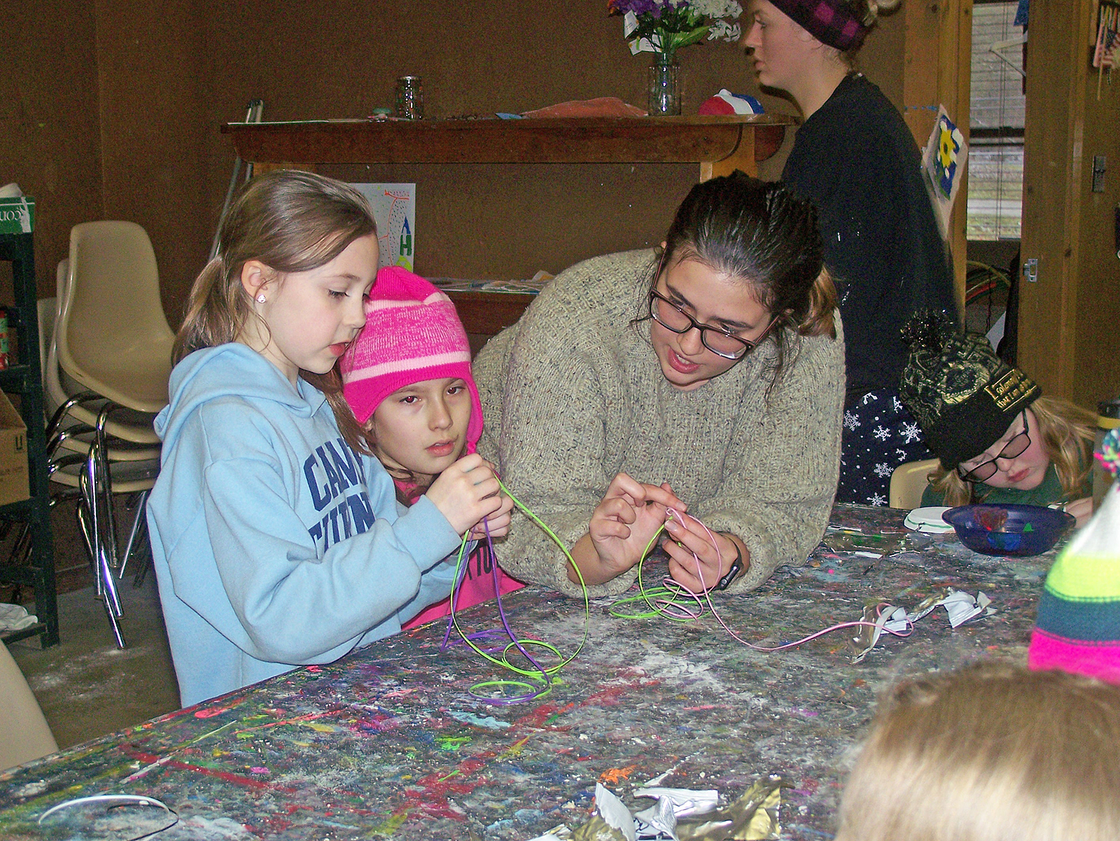 Anna Gullo teaches some young campers how to make a colorful boondoggle. Arts & crafts were just a small part of the activities offered at Camp Turner's annual winter camp. (Patrick J. Buechi/Staff ) 