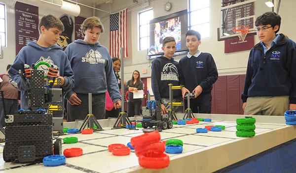 Students from St. John the Baptist in Alden face off against students from St. John the Baptist of Kenmore in the robotics competition at St. Joseph's Collegiate Institute during the all-area STREAM science competition. (Dan Cappellazzo/Staff Photographer)