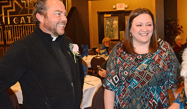 Father David Richards, recipient of the Nelson Baker Award for his work with area young Catholics, speakers with proud family members during the annual Catholic Youth Awards Dinner at Lucarelli's Banquet Hall. (Dan Cappellazzo/Staff Photographer)
