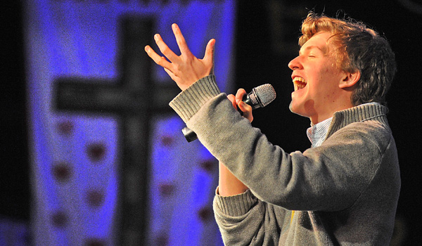 An emotional Jesse Brodka of St. Benedict Parish in Eggertsville sings `Now God,` a song he co-wrote with Charlie DeRose of St. Francis Parish in Tonawanda, at the Adam's Mark Hotel Grand Ballroom during the final day of the 65th-annual Diocese of Buffalo Youth Convention. (Dan Cappellazzo/Staff Photographer)
