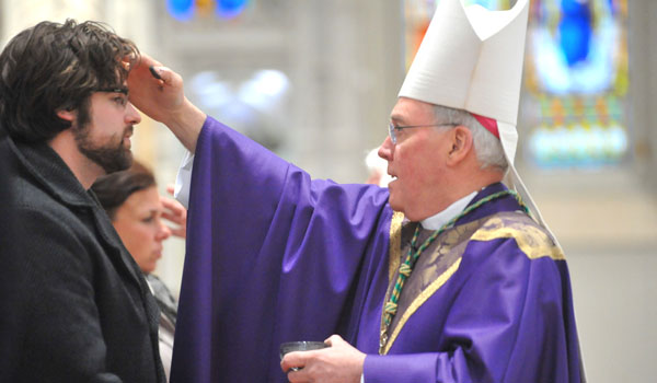 Bishop J. Malone will distributes ashes during Ash Wednesday celebration at St. Joseph Cathedral. (WNYCatholic File)