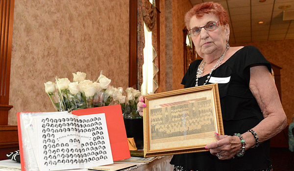 Bishop McMahon High School alumna Janice Mings, holds a copy of the 1957 graduating class picture. Several alumnae attended lunch together at Classics V restaurant in Amherst. (Patrick McPartland/Managing Editor)
