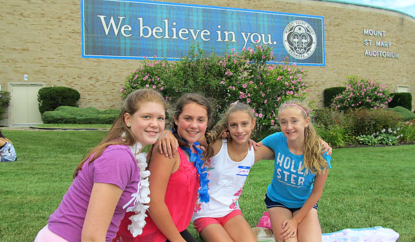 Campers enjoy a `beach` picnic on the front lawn of Mount St. Mary Academy during the school's summer sessions day camp.