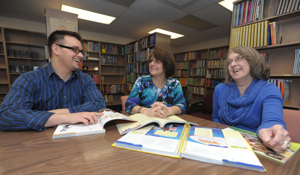 Mario Vinto (from left), Mary Beth Coates and Maureen Poulin share time to discuss the upcoming catechetical leadership conference. (Patrick McPartland/Staff Photographer)