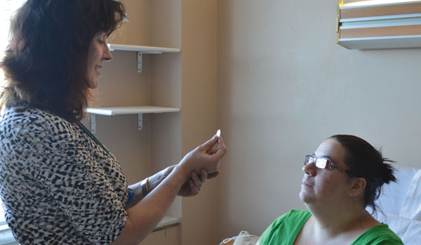 Cindy Zielinski brings the Eucharist to those at Sisters Hospital in Buffalo. (Catholic Health)