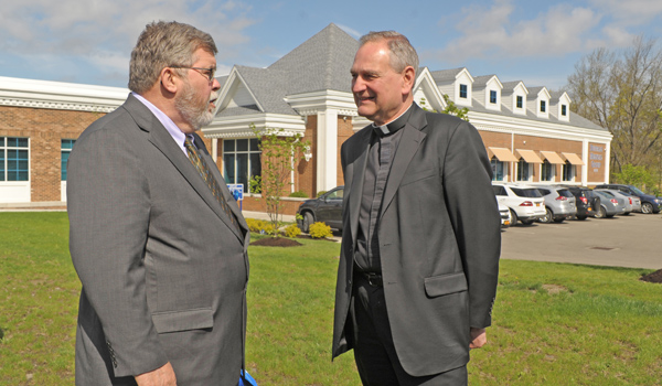 Msgr. Robert E. Zapfel, chairman of corporate members and sponsors for Catholic Health, speaks with Catholic Health Chief Executive Officer Joseph McDonald outside of the new 5,000-square-foot radiation oncology center on Buffalo Road in Orchard Park after a groundbreaking ceremony.  The facility is a collaboration between Roswell Park, Catholic Health and Buffalo Medical Group. (Dan Cappellazzo/Staff Photographer)