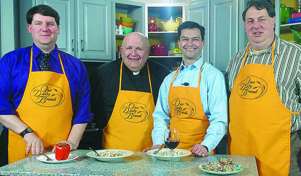 On this month's `Our Daily Bread,` Father Paul D. Seil (second left) will be joined in the kitchen by (from left) Patrick McPartland, managing editor of the Western New York Catholic; George Richert, director of communications; and Gregg Prince, assistant director of communications for radio. (Courtesy of Daybreak TV Productions)