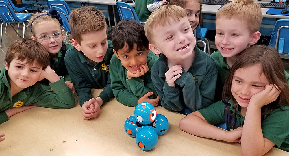 First-graders at St. Benedict School are introduced to Dash and Dot their new coding companions. (Courtesy of St. Benedict School)