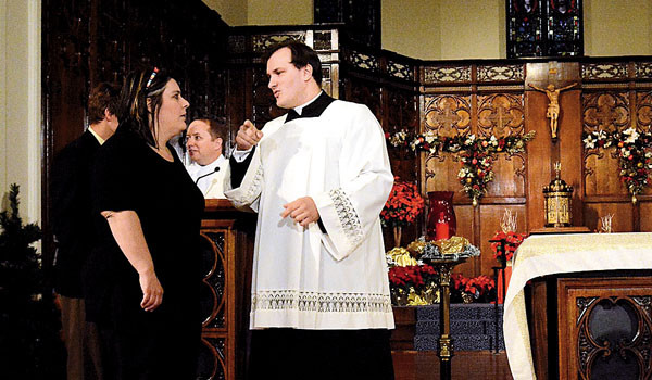 Daybreak TV Producer Paula DeAngelis-Stein speaks with Secretary to the Bishop Father Ryszard Biernat at the taping of the Christmas Mass in the Mercy Chapel in Buffalo which will be carried by NBC affiliates.