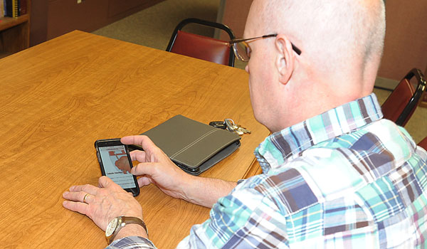 Richard Suchan uses the digital Diocesan Directory on his smartphone.