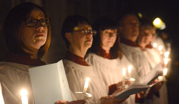 The Cathedral Choir listens to readings by candle light during the Easter Vigil Mass at St. Joseph Cathedral. (Patrick McPartland/Staff Photographer)