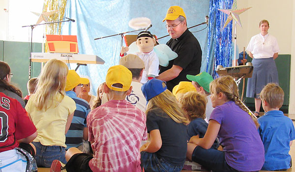Father David E. Tourville with campers as part of a vacation Bible school organized by Morning Star of St. Mary of the Angels Church, Olean. (Courtesy of Morning Star)
