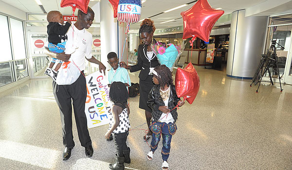 Fidele Diing Dhan is reunited with his wife, Abang Garang Kuol, and their children Abuk, Lok and Gau at the Buffalo/Niagara International Airport. (Patrick McPartland/Managing Editor)