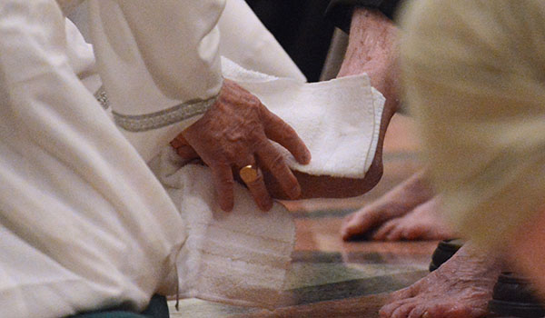 Bishop Richard J. Malone washes the feet of 12 volunteers during Mass of the Lord's Supper at St. Joseph Cathedral. (Patrick McPartland/Managing Editor)