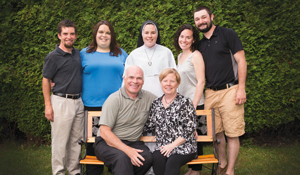 Sister Dominica stands behind her parents, Deacon Mark and Linda Hooper. Other members of the family include (standing from left) Timothy and Jamie Hooper, and Mary and Jeff Skrzynski. (Courtesy of Linda Hooper)