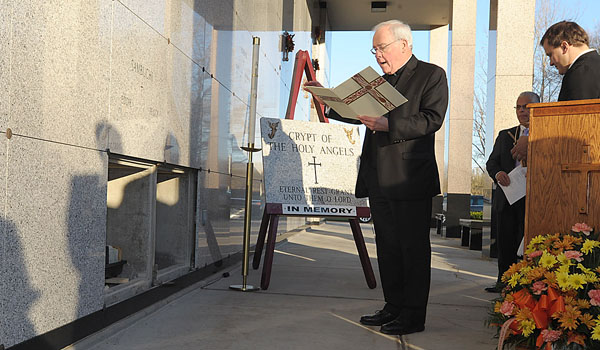 Bishop Richard J. Malone gives a blessing during a committal service for unclaimed cremated remains. The service was held at Holy Cross Cemetery in Lackawanna on the Feast of All Souls outside Holy Trinity Mausoleum. The cremated remains are interred  in an exterior crypt titled Crypt of the Holy Angels with the inscription, `Eternal Rest Grant unto Them O Lord.` (Patrick McPartland/Staff Photographer)