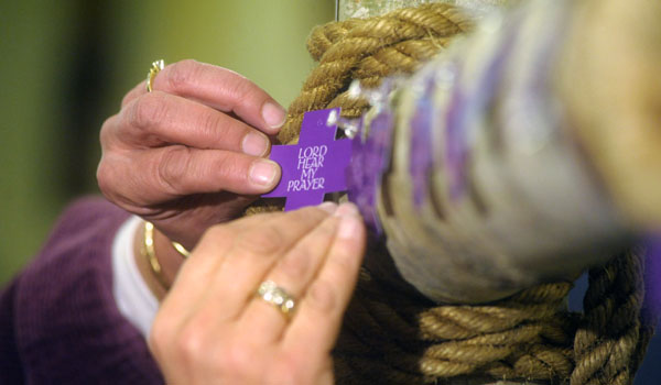 A small cross is pinned to the larger Lenten prayer cross at Holy Name of Mary Church in Ellicottville. Each of the smaller crosses contains a prayer or special intention. By the end of Lent the cross will contain thousands of crosses. 
(Patrick McPartland/Staff Photographer)