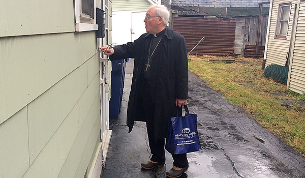 Bishop Richard J. Malone volunteered to help deliver Meals on Wheels to shut ins during the Christmas season.
(Courtesy of Meals on Wheels for WNY)