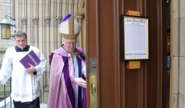 Bishop Richard J. Malone blesses and opens the Mercy Doors during a special ceremony at St. Joseph Cathedral. The opening of the doors signifies the beginning of the Jubilee Year of Mercy for the Catholic Church and signifies the welcoming of all to the Church
(Patrick McPartland/Staff Photographer)
