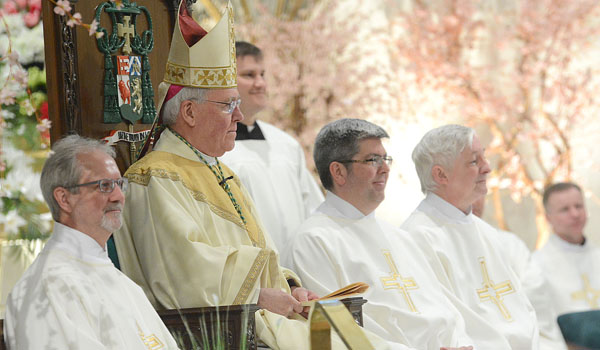 John Owczarczak, Peter Donnelly and David Armstrong join Bishop Richard Malone on the altar during the ordination to the diaconate at St. Joseph Cathedral.
(Patrick McPartland/Staff Photographer)