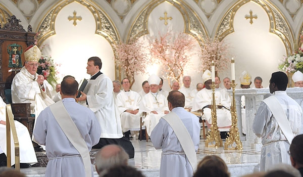 Bishop Richard J. Malone addresses the three men being ordained as part of the rite of ordination to the priesthood. The ceremony took place at St. Joseph Cathedral. (Patrick McPartland/Staff Photographer) 