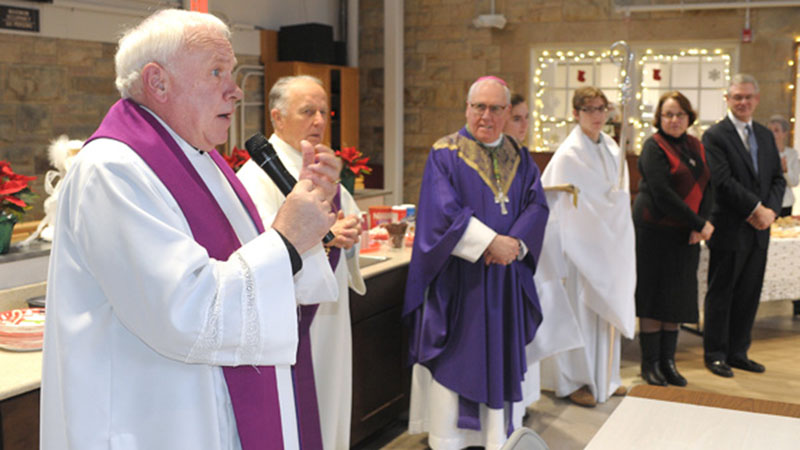 Flanked by Bishop Richard J. Malone, fellow members of the clergy and St. Paul Church board members, Father Joseph E. Vatter (left) thanks the congregation during a blessing of the new St. Paul Church Parish Center. The center, which will be utilized by the parishioners and the community, is located behind the Kenmore church. (Dan Cappellazzo/Staff Photographer)