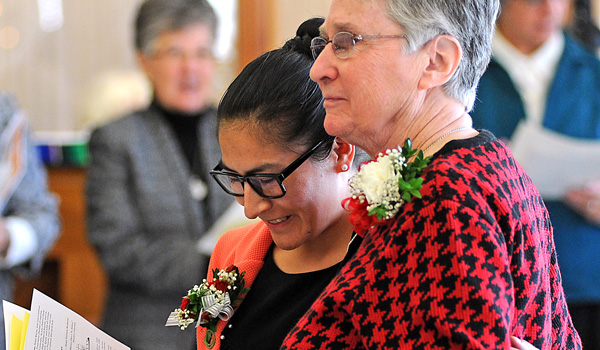 Sister Barbara Jean Donovan, general minister of the Sisters of St. Francis of the Neumann Communities, hugs an emotional Sister Reyna Jesusa Ontón Ñahui after she professes her perpetual vows during a Eucharistic liturgy at 11 a.m., Saturday, Dec. 10 at the St. Mary of the Angels convent chapel, 301 Reist Street in Williamsville, New York. (Dan Cappellazzo/Staff Photographer)