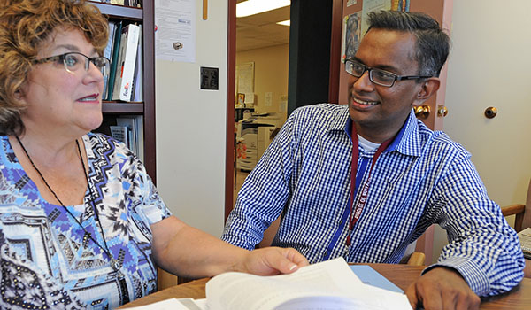 Director of Pro-Life Activities Cheryl Calire speaks with field education student Kevin Upendran at the Catholic Center. (Dan Cappellazzo/Staff Photographer)