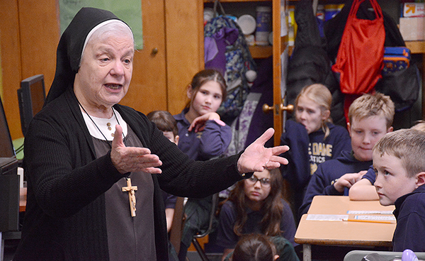 Sister Johnice speaks to fourth grade students at Notre dame Academy in South Buffalo about the importance of giving and helping others. The students presented Sister Johnice with box of money they raised through their good deeds. The money will help fund meals at the Response to Love Center. 
(Dan Cappellazzo/Staff photographer)
