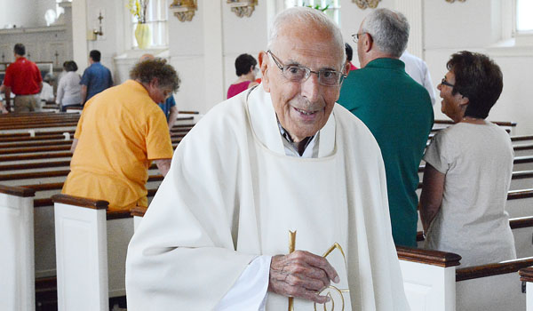 At 95 years old, Msgr. Dino Lorenzetti still lives out his vocation as he celebrates Mass at St. John the Baptist Church in Kenmore. (Patrick McPartland/Managing Editor)