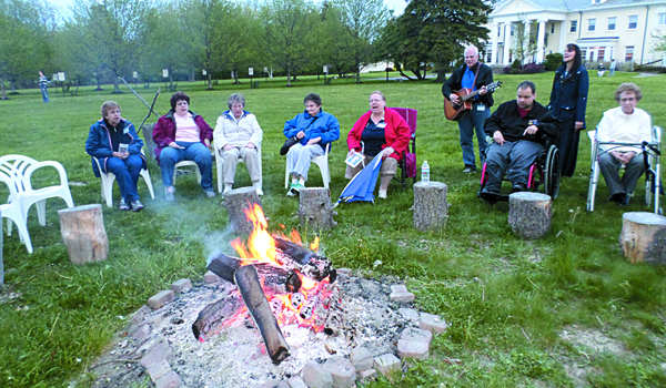 Participants gather at a bonfire as part of a prayer service during the retreat.
