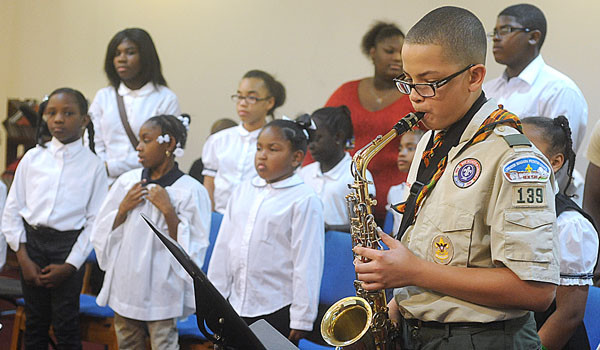 Brandon Barksdale plays the saxophone with the St. Martin de Porres youth choir at the revival `Walk by Faith, Walk in Faith, Walk through Faith.` Sponsored by the Diocesan African American commission and Office of Cultural Diversity, Diocese of Buffalo the revival featured Father Arthur Cavitt, a priest of the Archdiocese of St. Louis. (Patrick McPartland/Staff Photographer)