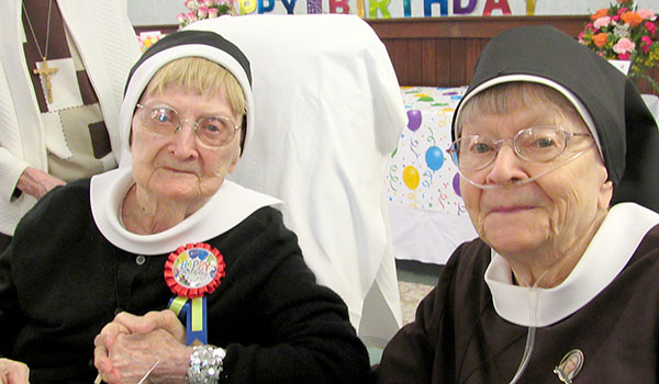 Sister Mary Fidelma Kakol, CSSF (left), celebrates her 100th birthday with her biological sister, Sister Mary Henriella Kakol, CSSF. (Courtesy of Felician Sisters)